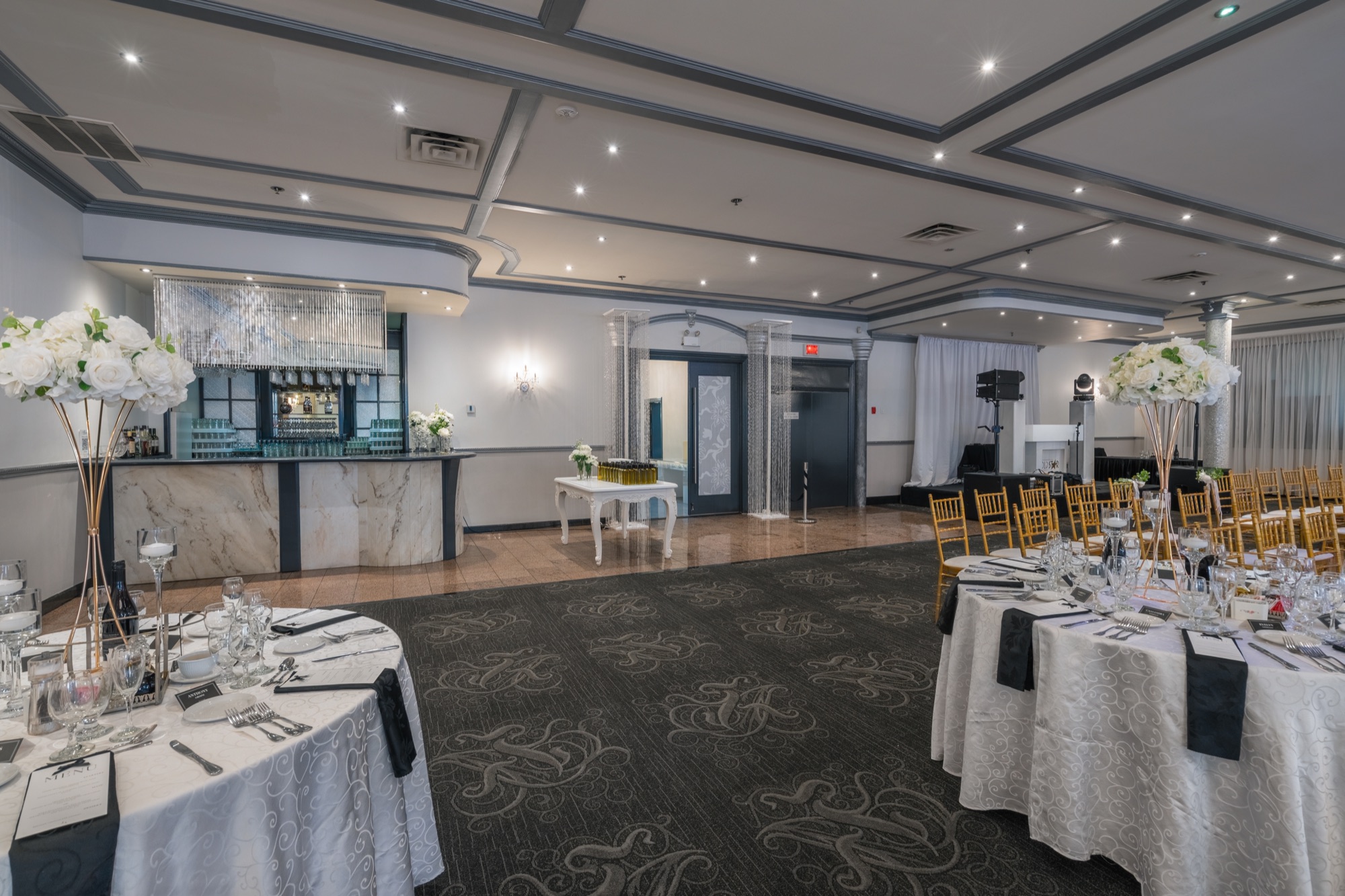 Set tables near a bar in a bright hall